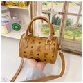 Detailed macro view of the brown bear pattern embossed on the textured mini Boston bag - Brown
