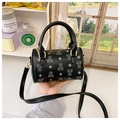 Detail of black Boston bag featuring bear patterns and polished gold-tone hardware - Black