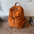 Minimalist caramel orange nylon backpack with drawstring front pocket for travel - Orange