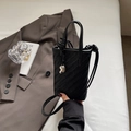 Mini black woven bucket bag with silver heart charm and adjustable shoulder strap - Black