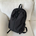 Minimalist black backpack with asymmetric diagonal zipper and woven rope pullers - Black