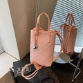 Pink woven mini bucket bag with silver heart charm and adjustable shoulder strap - Pink