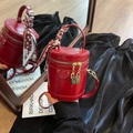 Elegant red bucket bag with gold lock hardware and decorative silk scarf handle - Burgundy