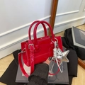Red patent leather crossbody bag with silver star charm and round top handles - Red with Pendant