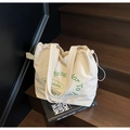 Off-white canvas drawstring tote bag with green 'Bring Color To Your Life' print - Off White