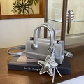 Silver metallic leather handbag with star and balloon dog charms on black books - Silver (With Pendant)