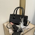 Modern black patent leather crossbody bag with oversized silver star charm accessory - Black with Pendant