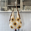 Beige crochet knit tote bag with yellow sunflower patterns and brown leather strap - Colorful
