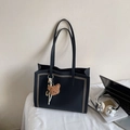 Minimalist black tote bag with silver rivets, teddy bear charm and striped scarf accent - Black