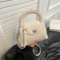 Chic off-white bucket bag with vertical pleats, litchi grain flap and silver metal lock - White