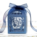 Detailed macro view of laser-cut horse and rose patterns on a navy blue gift box - Magic Blue