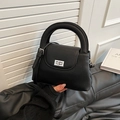 Versatile black vintage bucket bag with pleated texture and silver twist lock detail - Black