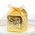 Detail showing laser-cut rose patterns on a gold candy box with translucent ribbon bow - Reflective Gold