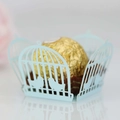 Close-up of laser cut light blue birdcage candy box with intricate silhouette details - Pearl Pale Blue