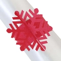 Vista macro de un servilletero de papel rojo con forma de copo de nieve cortado a láser - Rojo Perlado