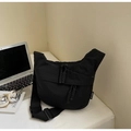 Detail of black nylon crescent crossbody bag featuring dual zippers and adjustable wide strap - Black Small