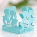 Detail of light blue pearlescent paper cake wrapper with laser-cut boy and girl silhouette - Tiffany Blue
