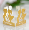 Detail of laser-cut gold paper wrapper featuring romantic boy and girl silhouette - Reflective Gold