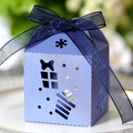 Detail of light blue house-shaped paper gift box with snowflake laser cutouts and blue ribbon - Sapphire Blue
