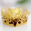 Detailed macro view of laser-cut gold lace wrapper with intricate rose patterns for chocolates - Gold