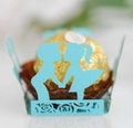 Macro shot of laser-cut blue cardstock chocolate wrap with boy and girl silhouettes - Tiffany Blue