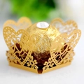 Macro view of gold laser-cut heart pattern cupcake wrapper for wedding party decor - Gold