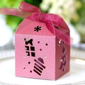 Close-up of pink hollow Christmas favor box with glitter finish and sheer ribbon bow - Dark Red