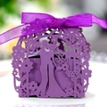 Close-up of purple laser-cut wedding favor box with romantic silhouette and ribbon - Dark Purple