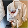 Detail shot of white PU shoulder bag featuring red bow prints and a 3D heart pendant - Blue