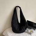 Large black hobo shoulder bag with knot strap detail on a minimalist white backdrop - Black