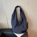 Minimalist navy blue oversized nylon tote bag with functional side pockets and knotted strap - Blue