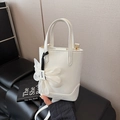 White leather bucket bag with elegant flower charm and fashion cross-body strap - White