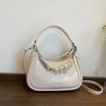 Minimalist beige dumpling bag with pearl heart chain and adjustable crossbody strap - Pink