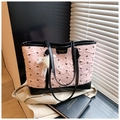 Detail of pink embossed tote bag with black bow embroidery and pearl lace charm - Pink with Pendant