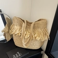 Beige hand-woven straw tote bag with long bohemian fringe accents and dual handles - Khaki
