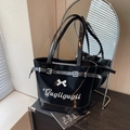 Black patent leather tote bag with white bow accent and Gugiigugii embroidery detail - Black