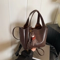 Dark brown matte leather bucket bag with top handles and a cute bear charm accessory - With Charm / Brown