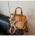 Detail of monogram bucket bag with dog charm and adjustable leather shoulder strap - Dark Khaki With Pendant