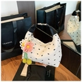Close-up of white ruched handbag featuring black bow patterns and floral charm detail - White with Pendant