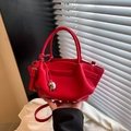 Chic red bucket bag with lychee texture featuring a silver heart charm and strap - Red