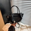 Classic black bucket bag in lychee texture with silver bean pendant and top handle - Black