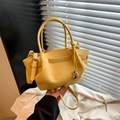 Chic lemon yellow bucket bag with lychee texture leather and a silver metal pendant - Yellow
