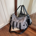 Grey nylon multi-pocket tote bag with black leather straps and adjustable wide shoulder strap - Gray