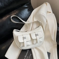 White faux leather crescent bag with double front utility pockets and silver metal buckles - White