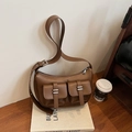 Vintage brown leather crossbody bag featuring dual front cargo pockets and silver hardware - Brown
