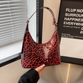 Chic red and black leopard print hobo bag in glossy finish with gold hardware - Red