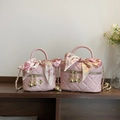 Pink quilted mini crossbody bag with silk scarf handle and golden camellia pendant - Small / Pink