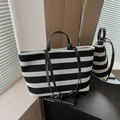 Fashionable black and white striped knit tote bag with black leather handles and shoulder strap - Black