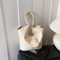 Minimalist cream litchi grain leather tote bag with elegant decorative pendant - Off White