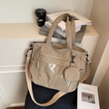 Khaki nylon tote bag with transparent PVC pocket and round coin purse in a lifestyle setting - Khaki